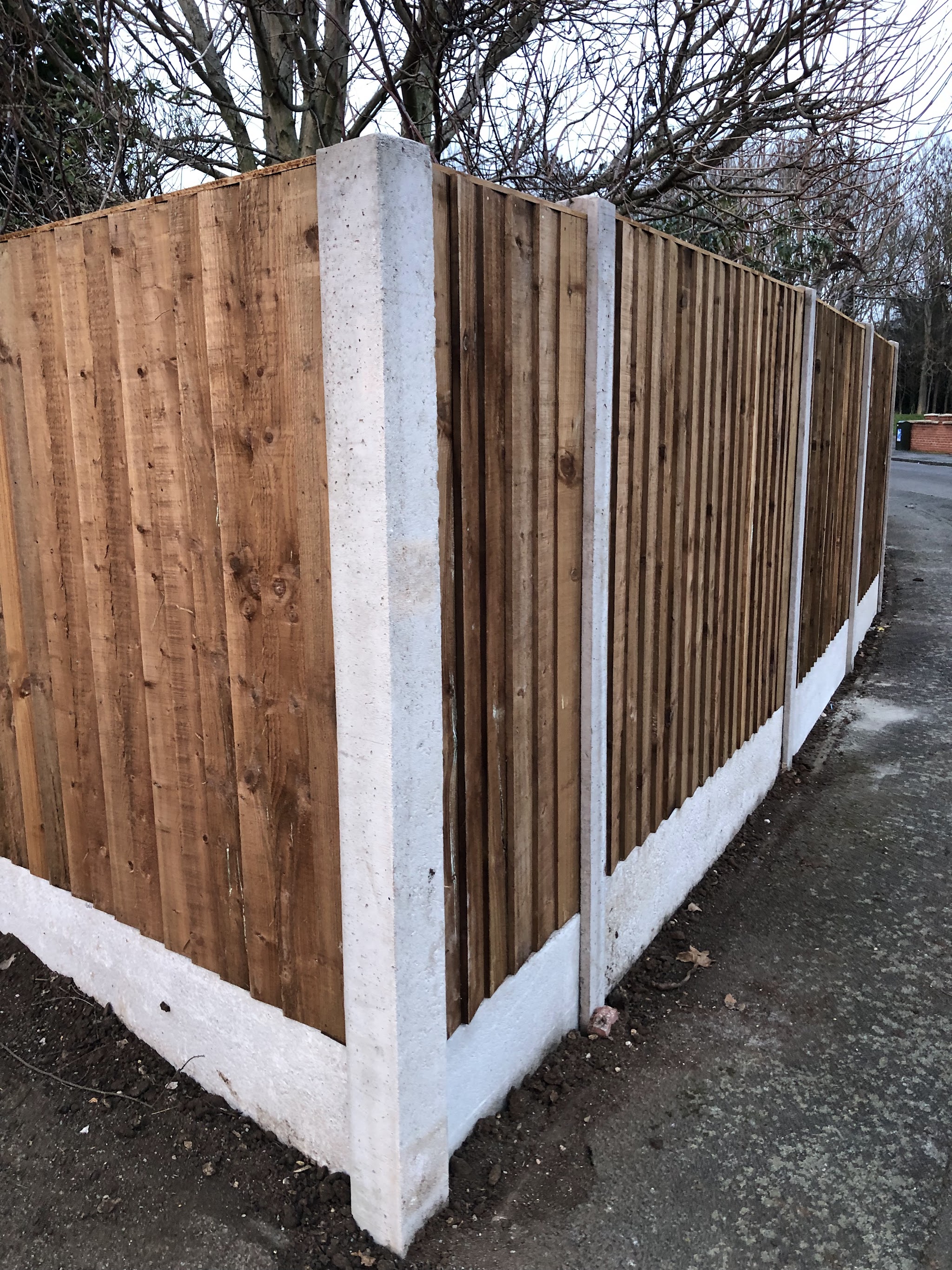 Feather-edge fencing with concrete posts and gravel boards, fitted by Hill’s Fencing